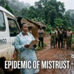 Cinematic photojournalism style editorial shot set in a rural Congolese village edge bordering a dense tropical rainforest in the Democratic Republic of the Congo. In the foreground, a Black Congolese healthcare worker wearing a protective medical apron and holding a clinical clipboard pauses solemnly beside a dusty white all-terrain emergency response vehicle on a damp, red-clay dirt road, their face etched with fatigue and solemn concern. In the soft-focus background, local community members observe with guarded, skeptical postures from the edge of lush village foliage. Atmospheric overcast lighting with subtle tropical mist filtering through the canopy, capturing profound tension and humanitarian weight, shot on a 35mm lens with rich documentary texture and depth of field. Displayed prominently across the lower third is bold, modern sans-serif typography reading "EPIDEMIC OF MISTRUST" in stark pure white lettering, enhanced with a subtle dark charcoal outer glow and soft drop shadow to ensure razor-sharp readability and maximum contrast against the muted tones of the earth and forest floor.